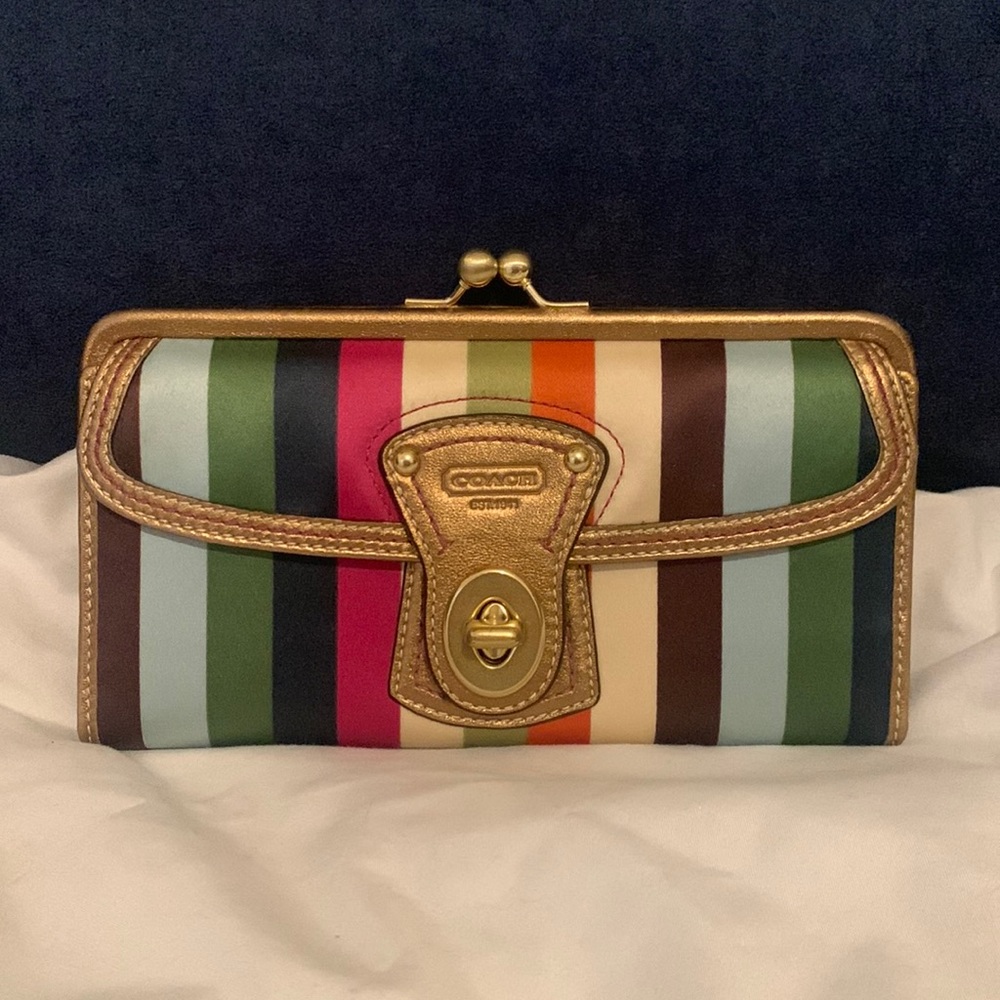 COACH multi color clutch featuring turn lock